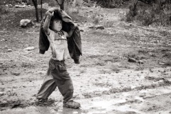 Kid walking under the rain, El Jaral, Mexico, 2002